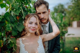 Surrounded by the quiet beauty of a vineyard park, the couple stands close together, sharing a wordless connection in Budapest, Hungary under soft evening light.